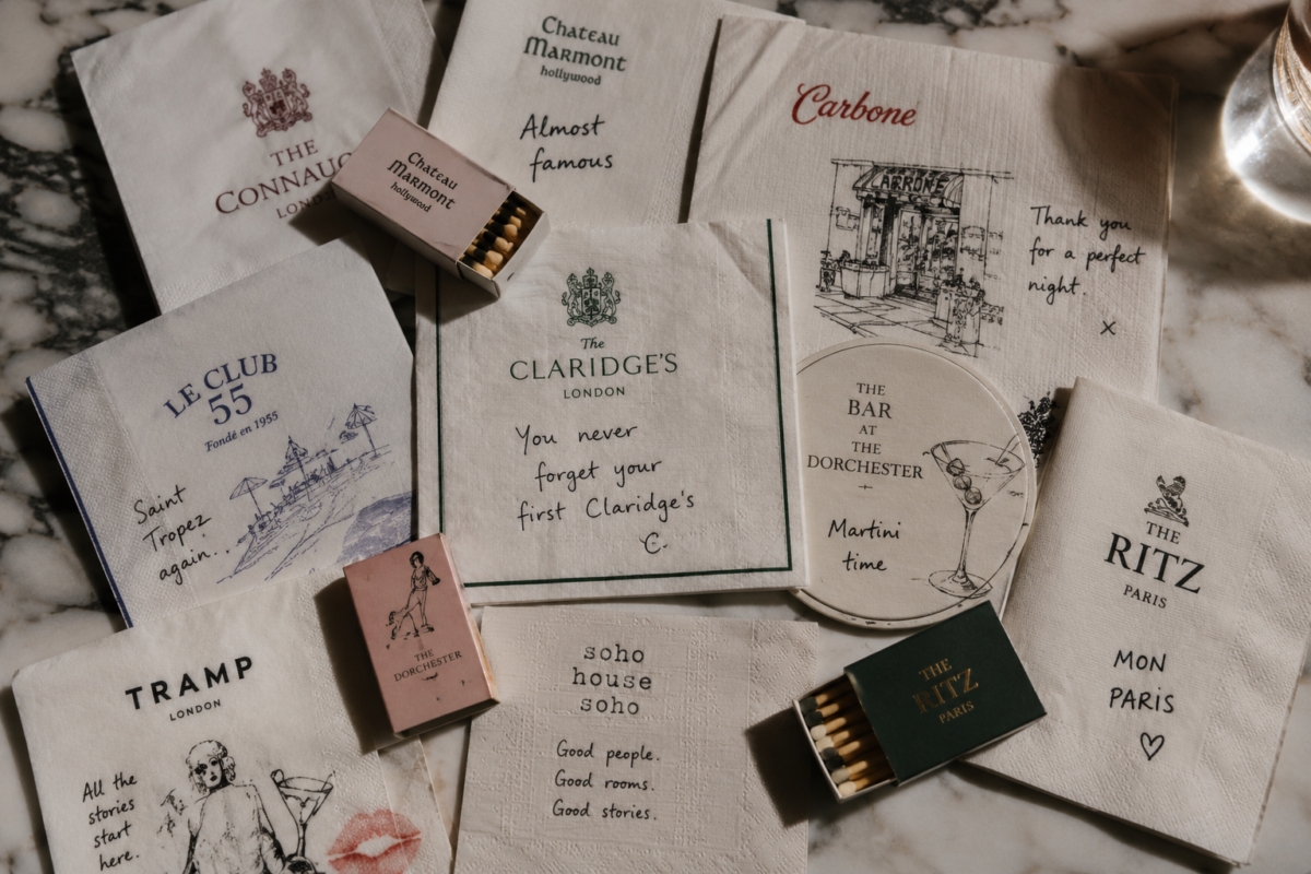 Charlie Child-inspired napkins, matchboxes and coasters arranged as collectible hotel and restaurant ephemera