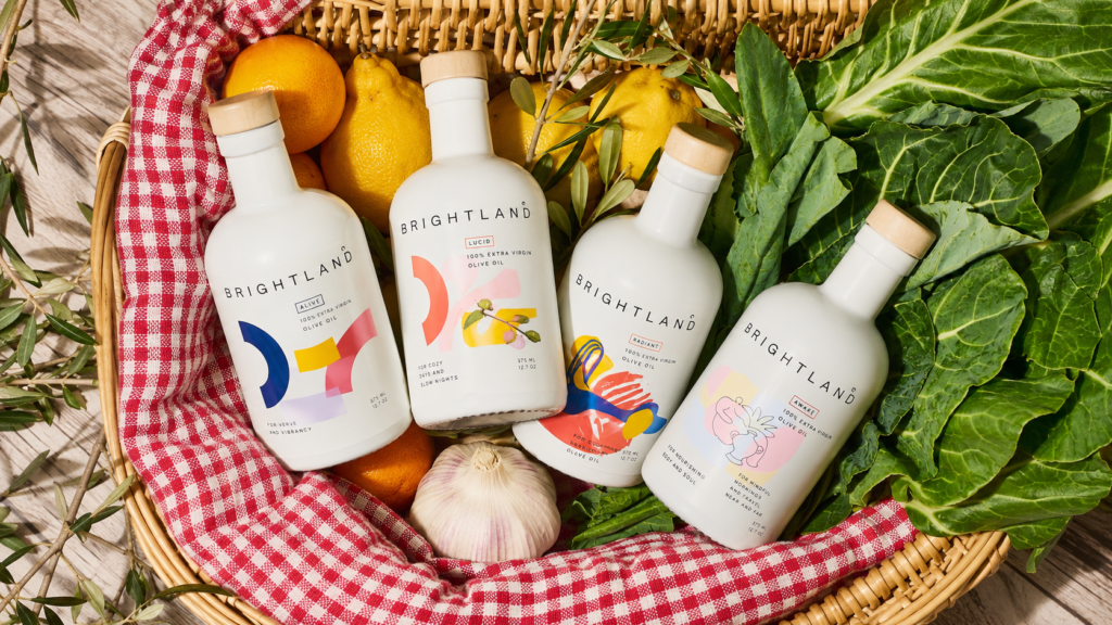 Brightland: When Did Olive Oil Become a Design Object? Brightland extra virgin olive oil bottles with fresh produce in a picnic basket